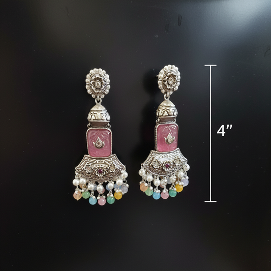 Decorative earrings and measurment with a white background