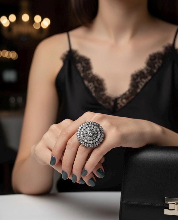 Woman wearing a large diamond ring with a blurred background