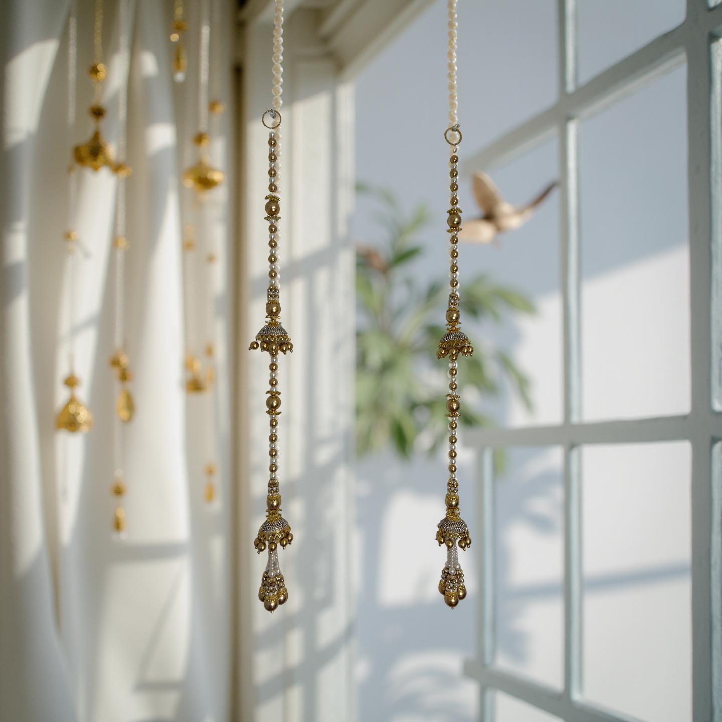 Decorative gold hanging beads in front of a window with sunlight filtering through.