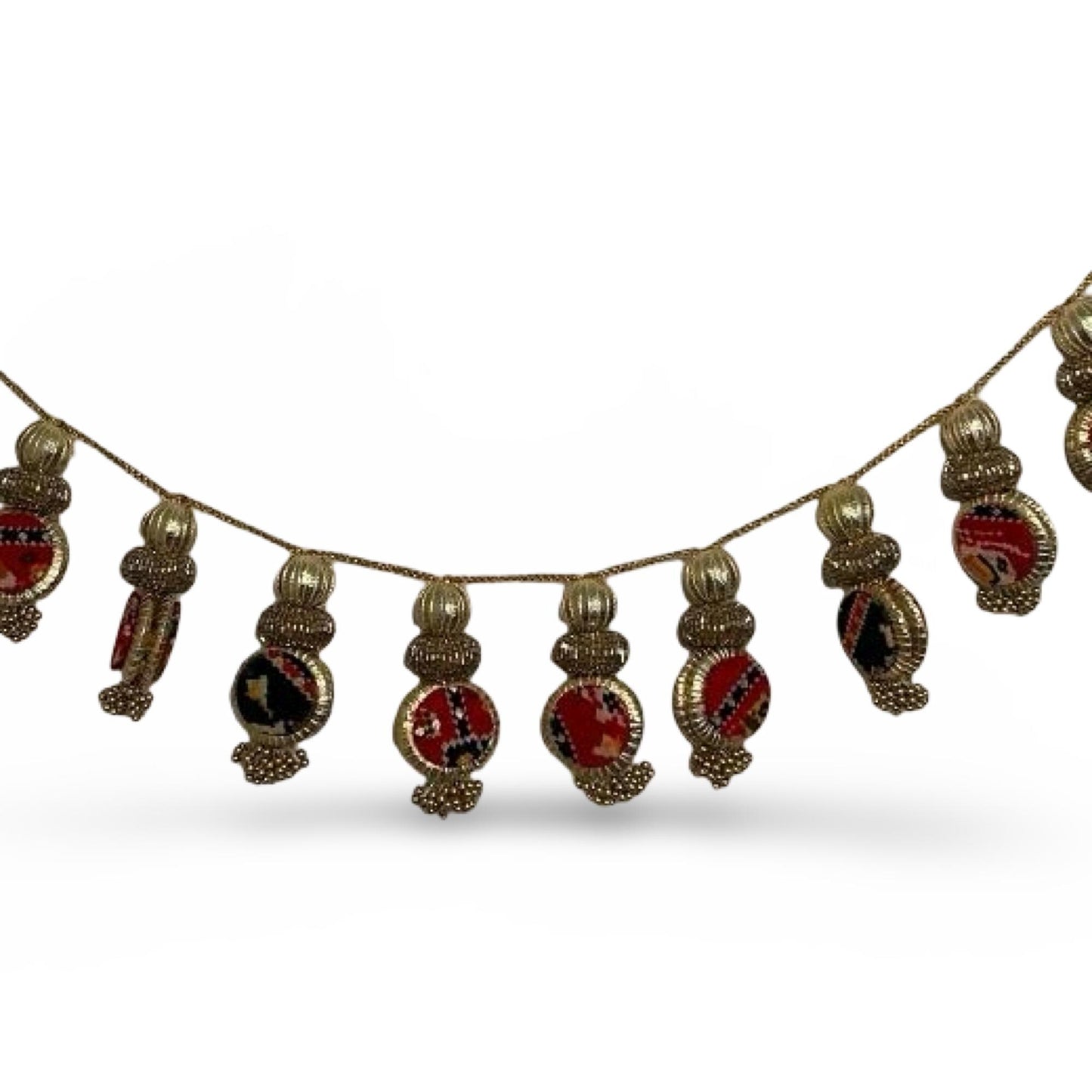 Decorative toran string with gold and red beads on a white background