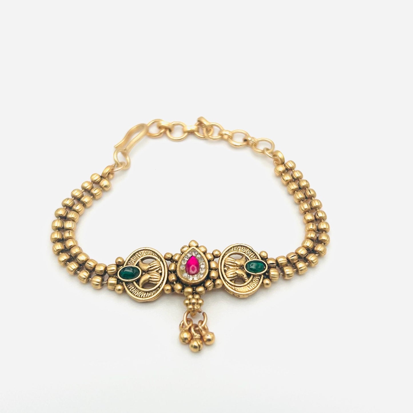 Gold bracelet with gemstones on a white background