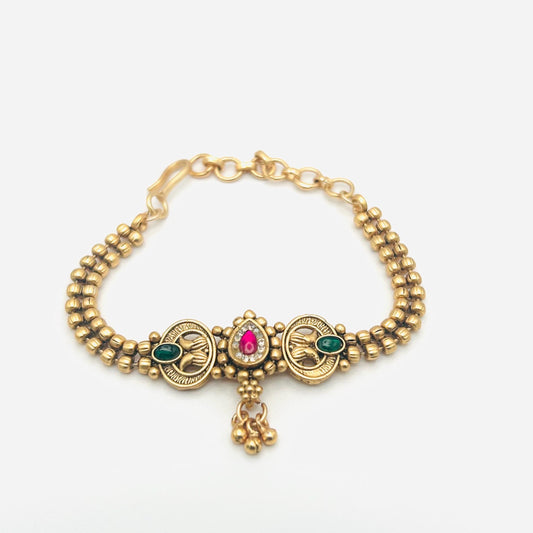 Gold bracelet with gemstones on a white background