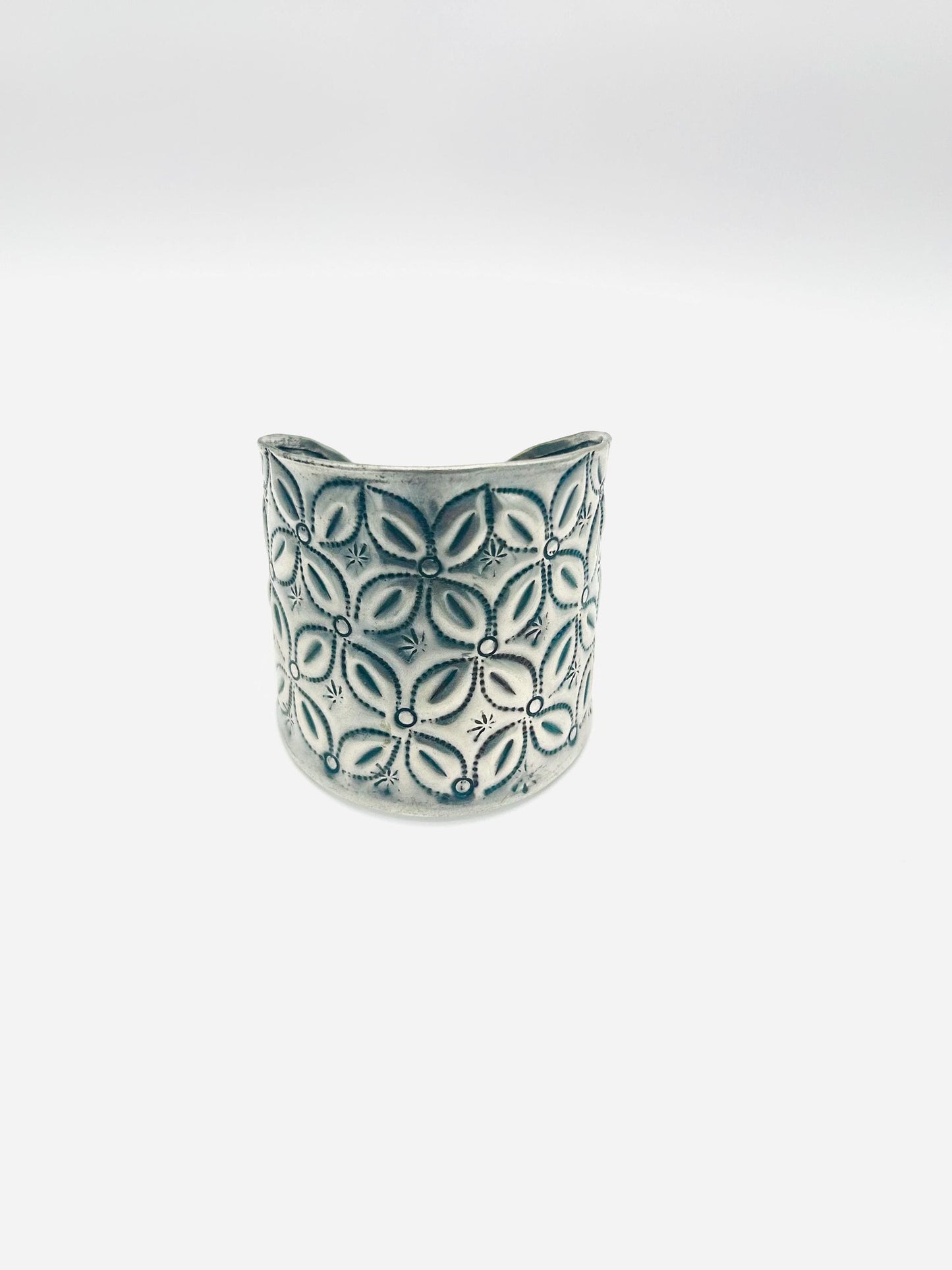 Ceramic vase with leaf pattern on a white background