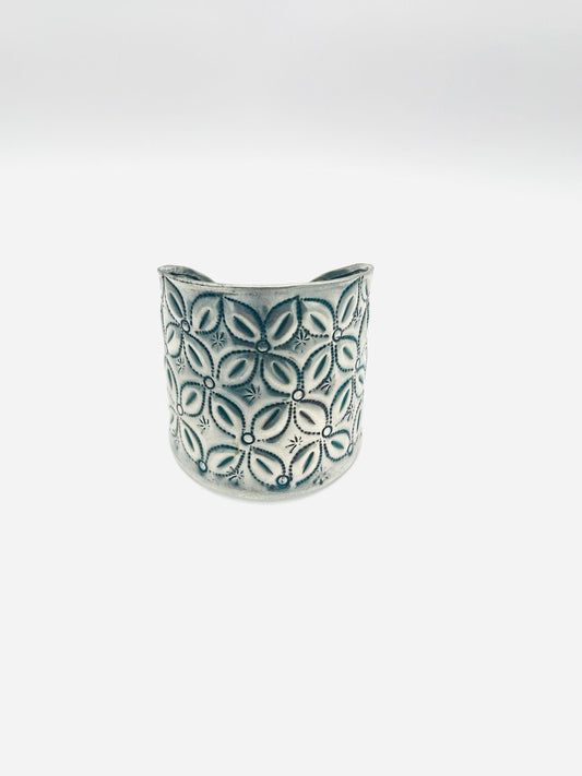 Ceramic vase with leaf pattern on a white background
