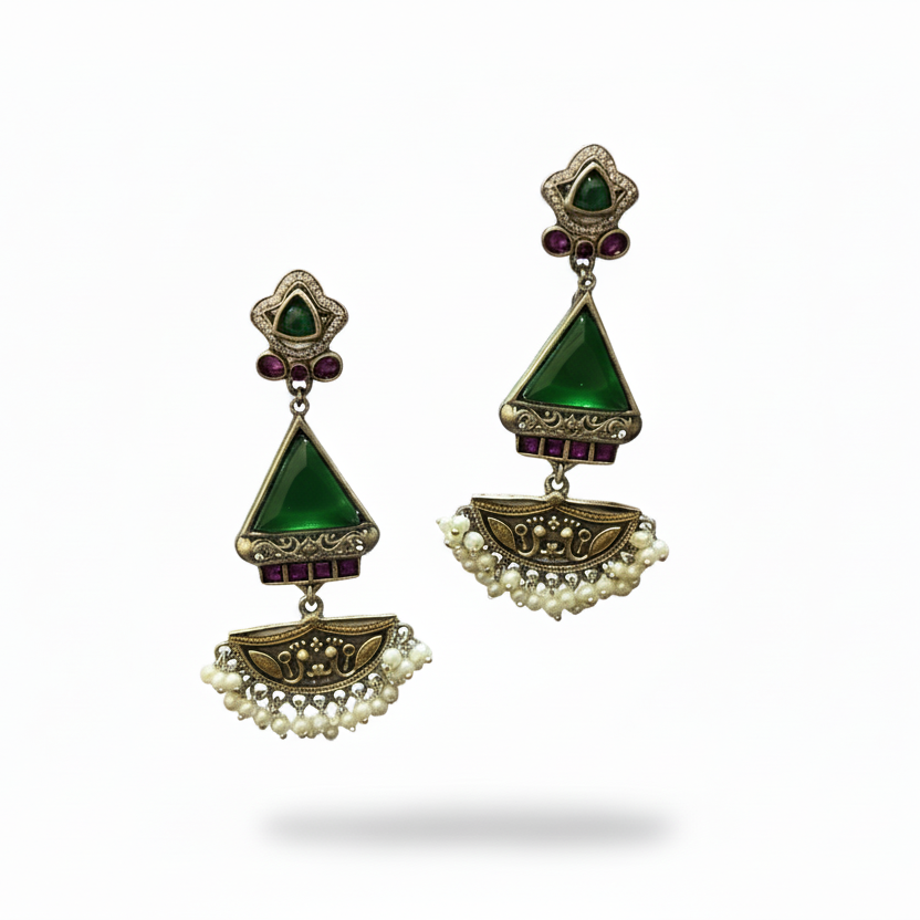 Pair of earrings with green gemstones and pearl accents on a white background