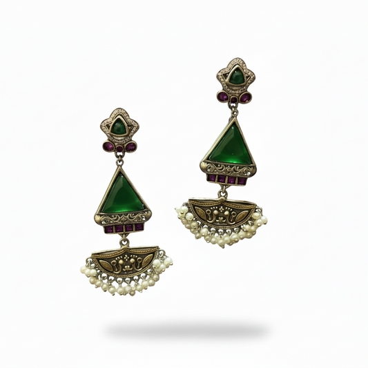 Pair of earrings with green gemstones and pearl accents on a white background
