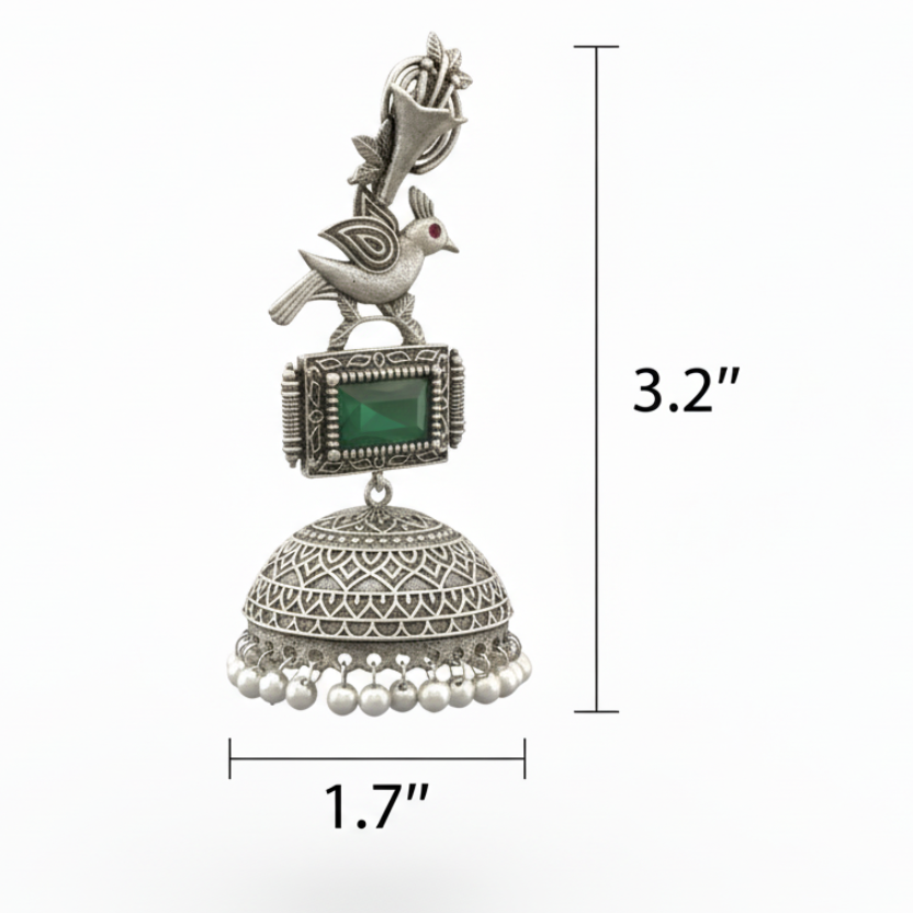 Silver jhumka earring with bird design and green gemstone on a white background